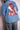 Man wearing blue denim jacket with colorful embroidered woman portrait and floral design on back