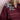 Close-up of a burgundy jacket sleeve with intricate rhinestone floral embellishments on the shoulder and pocket flap