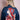 Back view of woman wearing dark blue denim jacket with colorful embroidered Asian woman and floral design