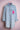 Light blue denim shirt with rolled sleeves and pink sequined patch on chest pocket on pink mannequin