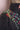 Close-up of dark denim jacket with colorful floral bead embroidery on shoulder and collar