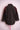 Back view of dark corduroy jacket with rolled sleeves and red beaded floral shoulder embellishments on pink mannequin