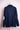 Navy blue knitted cardigan with collar, featuring artistic patches on elbows, displayed on stand