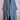 Blue denim kimono jacket with wide lapels and embroidered patches on pockets displayed on pink dress form