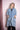 Woman wearing oversized blue denim kimono with gold bead embroidery on pockets