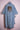 Light blue denim kimono with beaded tiger head design on back, displayed on pink hanger