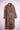 Leopard print trench coat with gold embroidered shoulder details on pink mannequin