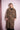 Blonde woman wearing a brown leopard print trench coat against pink backdrop