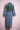 Long denim trench coat with rolled sleeves featuring embroidered green peacocks on the back